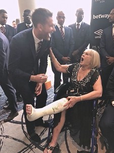 Patricia getting her 'cast' signed by Adrian